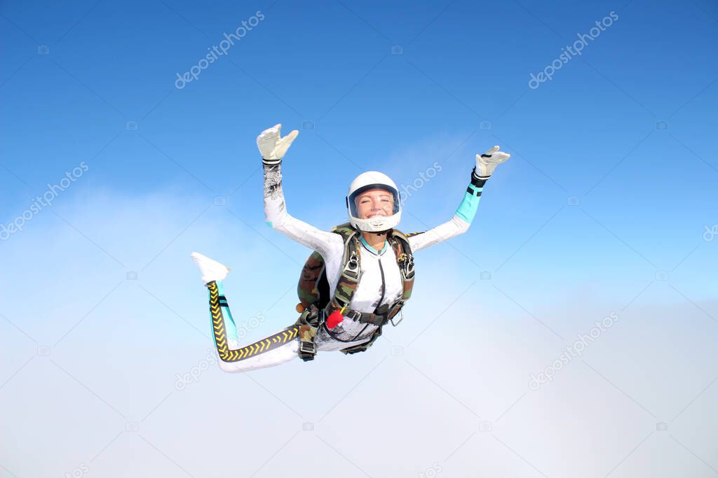 Skydiving. A happy girl is flying in the sky.