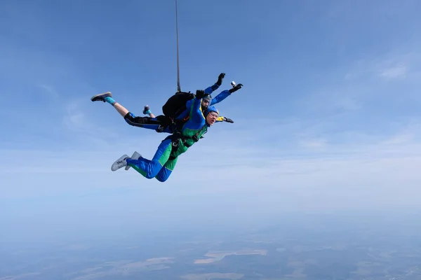 Skydiving. Tandem jump. Two guys are in the sky.