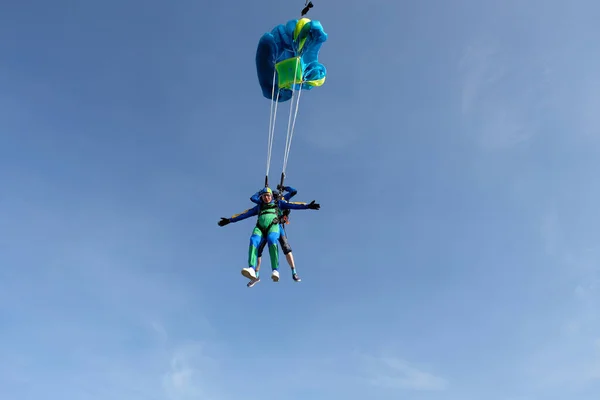 Skydiving. Tandem jump. Two guys are in the sky.