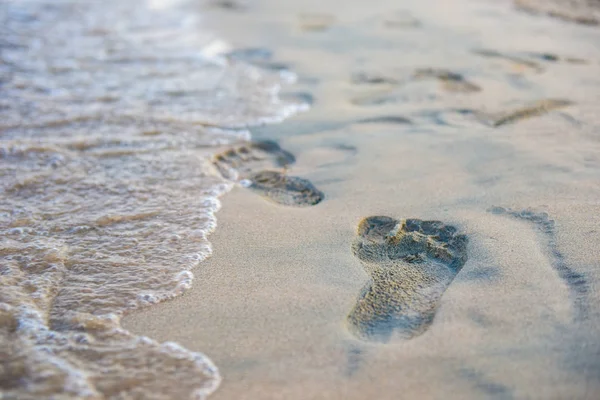 inspirational signs, text, pictures on a sand coast. Feet stand near the heart with arrow. Summer vacation sand beach inspire to travel on Valentines day. Romantic travel for love couples or family holidays. Relaxing sign I love you on yellow sand.