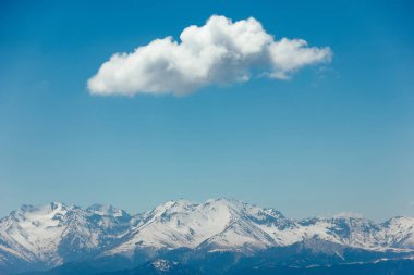 Kar, mavi gökyüzü, Caucasus üzerinde beyaz bulutlar dağların zirveleri ile kaplı