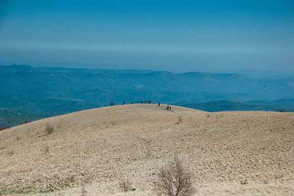 Tourists climb to the top of the Caucasus Mountains, Thach