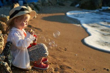Deniz ve gökyüzü arka plan karşı plaj rahatlatıcı çocuk. Yaz tatil ve seyahat kavramı                               