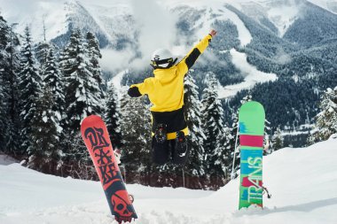 Bir snowboard yakınındaki bir tahta bir yamaçta atlıyor. Aşırı eğlenceli