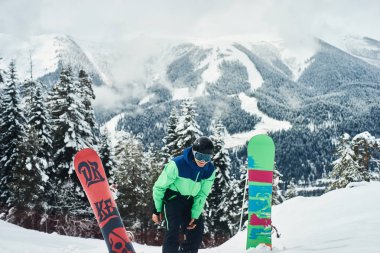 Arka planda derin mavi gökyüzü ile havada zıplayan snowboardcu