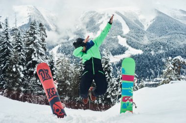 Bir snowboard yakınındaki bir tahta bir yamaçta atlıyor. Aşırı eğlenceli