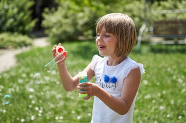 Sevimli küçük kız bir sabun baloncuklar üfleme