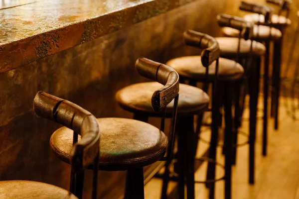 Vintage Row of wooden chairs, Interior background , Brown wooden chairs near the wooden bar of the bar