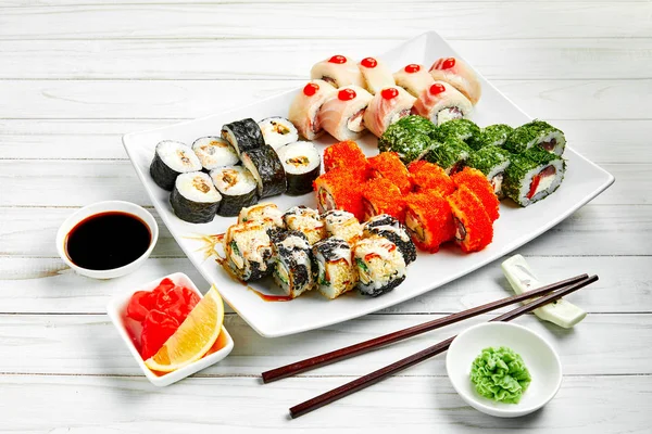 Closeup of traditional japanese sushi set with salmon and tuna fish isolated on white background. Sushi bar menu design with copyspace.