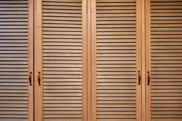 Rustic brown wooden window shutters, wall background