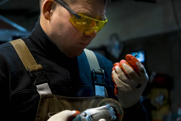 stock image Locksmith man in gloves and yellow glasses at work