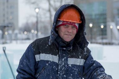 Buz kasabası kurmakla meşgul bir işçinin portresi.