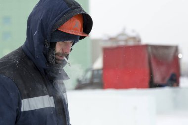 Buz kasabası kurmakla meşgul bir işçinin portresi.