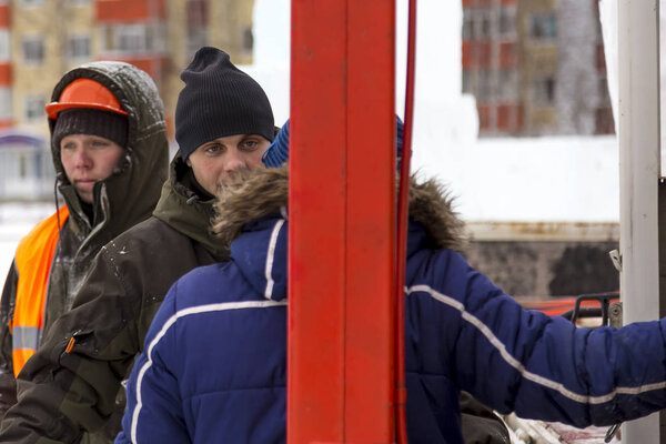 Workers at the construction site of the ice town for a conversation