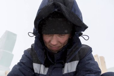 Buz kasabası kurmakla meşgul bir işçinin portresi.