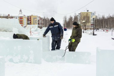 İşçi buz blok buz kamp derleme sitenin etrafına forseps ile çeker