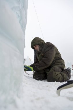 Elektrikçi Buz figürleri aydınlatmak için güç kablosunu bağlar.
