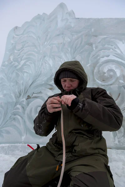 Electrician isolates the ends of the power cable to illuminate the ice figures.
