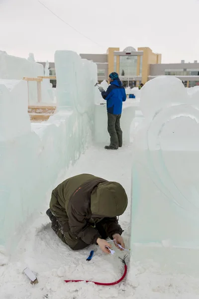 Electrician checks the health of the LED cable to illuminate the ice figures