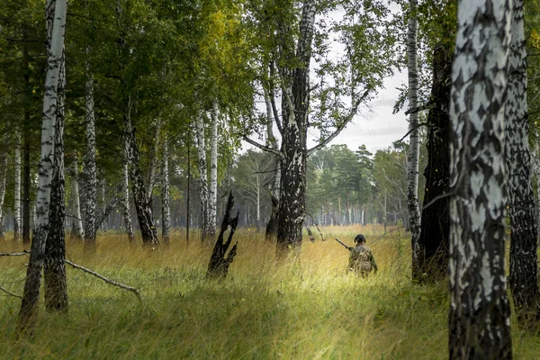 Hunter on a fishery in a birch grove — Stock Photo, Image