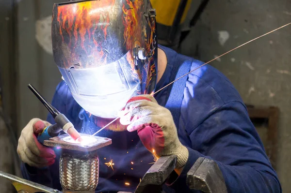 TIG welder welds a corrugation for a passenger car exhaust system