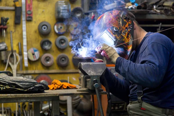 TIG welder welds a corrugation for a passenger car exhaust system