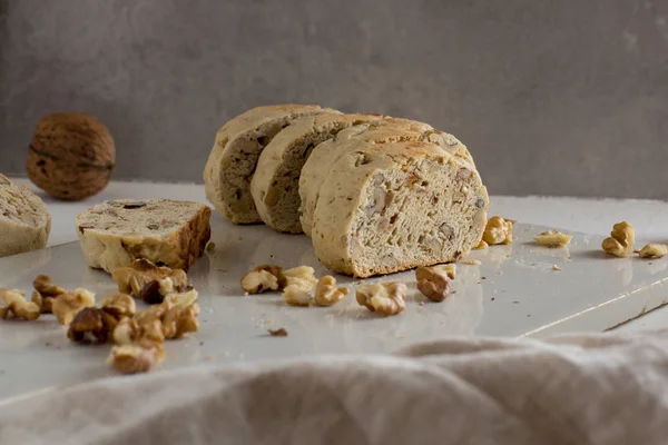 Homemade italian biscuits with nuts on white rustic cutting board close up. Healthy homemade food concept