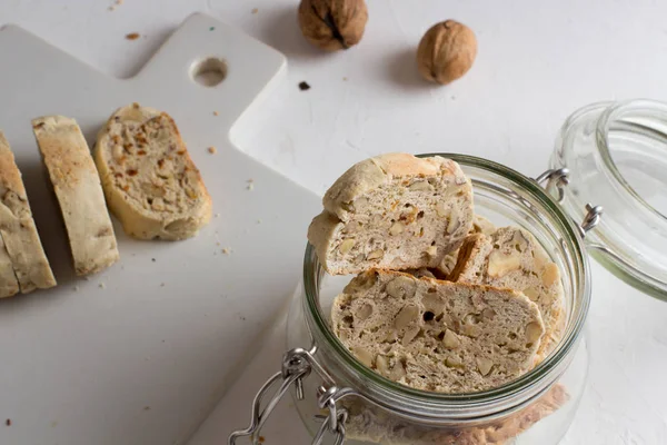 Homemade italian biscuits with nuts in transparent jar close up. Healthy homemade food concept