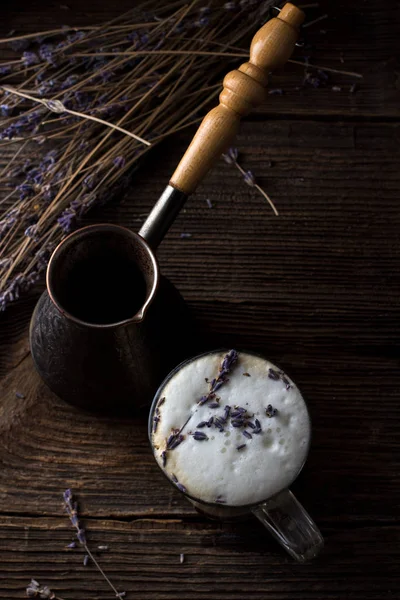 Arka planda lavanta dallar ile şeffaf bardak lavanta latte veya raf kahve düşük anahtar fotoğraf, yakın yukarı, arka ışık. Trendy koyu ve Moody tarzı