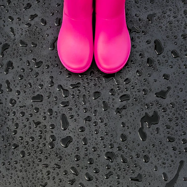 Trendy Bright Pink Rubber Boots Black Wet Surface Covered Raindrops — Stock Photo, Image