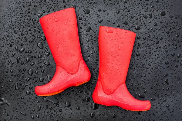 Trendy Red Rubber Boots Black Wet Surface Covered Raindrops Top — Stock Photo, Image