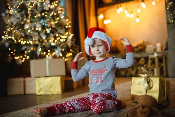 Little Blonde Toddler Girl Christmas Pajamas Trying Santa Hat Sitting — Stock Photo, Image
