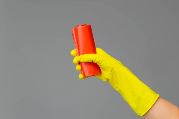 Hand Rubber Glove Holds Colored Garbage Bag Neutral Background Concept — Stock Photo, Image