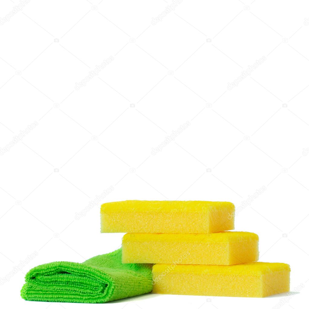 Yellow dish sponges and a green microfiber towel. Isolated on white background. Copy space.