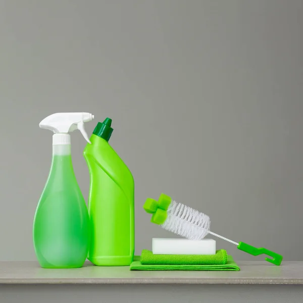 Green set of cleaning products and tools for spring cleaning.