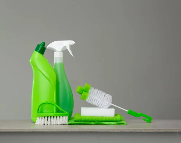 Green set of cleaning products and tools for spring cleaning.