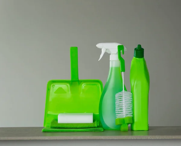 绿色洗涤剂瓶的厕所 喷雾瓶 勺子和灰尘在灰色的背景 清洁工具 — 图库照片