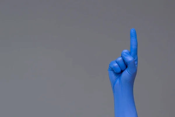 Hand Rubber Glove Points Upwards Index Finger Neutral Background Copy — Stock Photo, Image