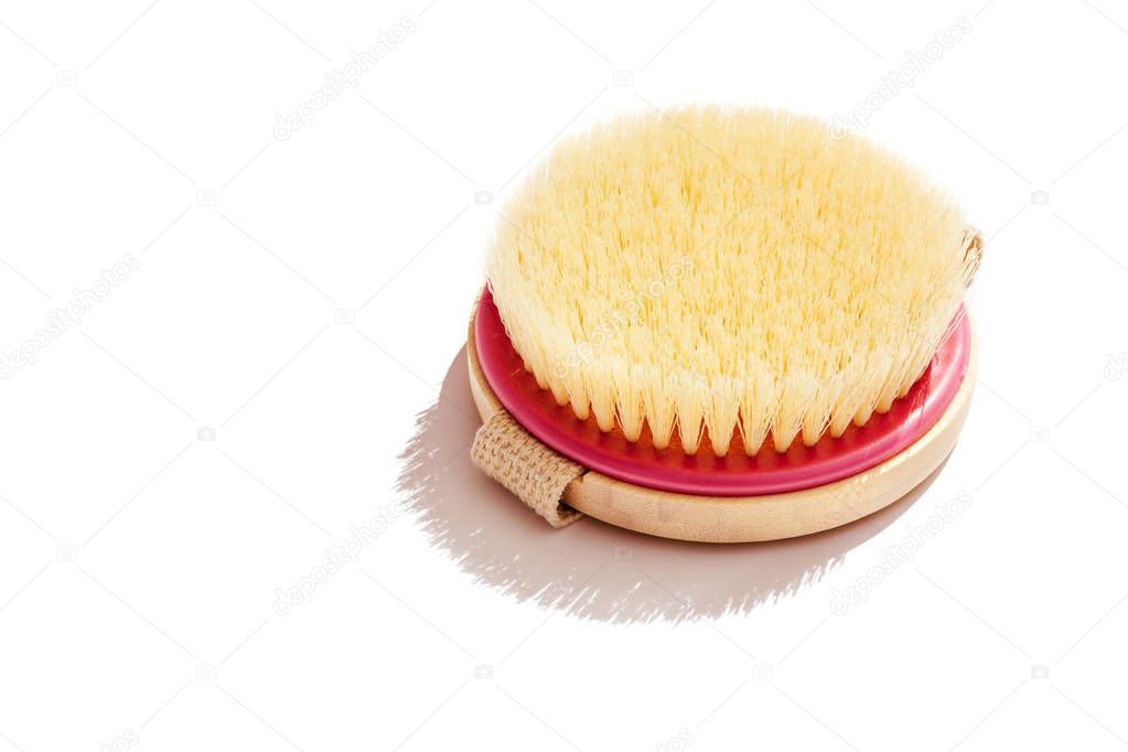 Dry body massage brush on white background at sunny day. Tool for smooth and soft skin. Copy space.