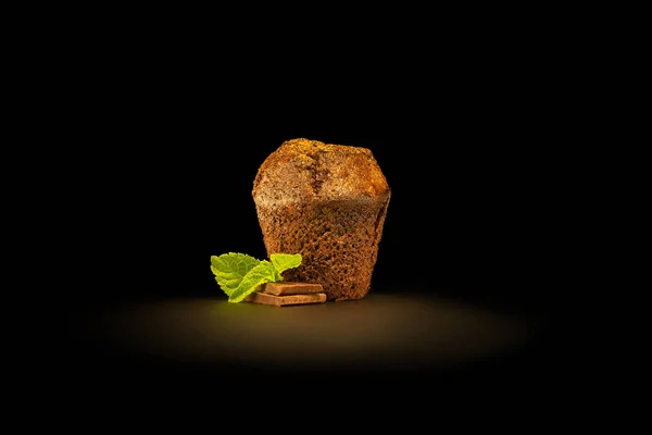 Muffin isolated on black background.