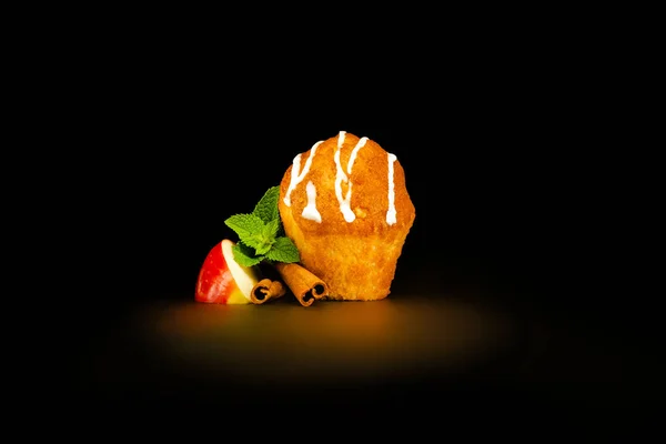 Muffin isolated on black background.