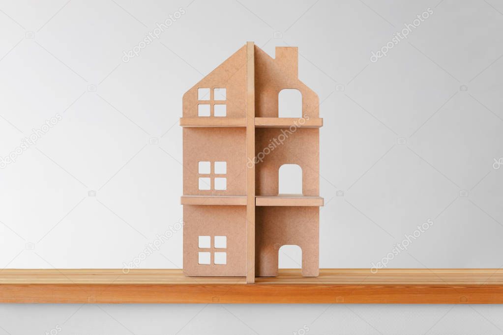 Toy wooden house - symbol of real estate.