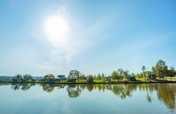 Summer lake on the territory of the country hotel with paid fishing.