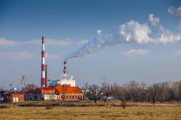 Smoking chimneys of heat and power plant in the background panorama of Wroclaw, Poland