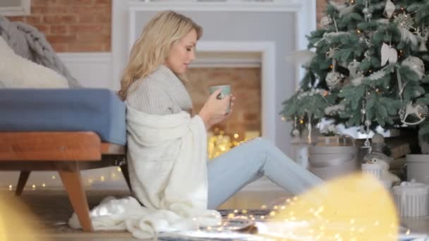 Mooi Meisje Buurt Van Kerstboom Met Een Kop Warme Drank — Stockvideo