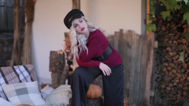 Blonde girl in a red sweater at a photo shoot — Wideo stockowe