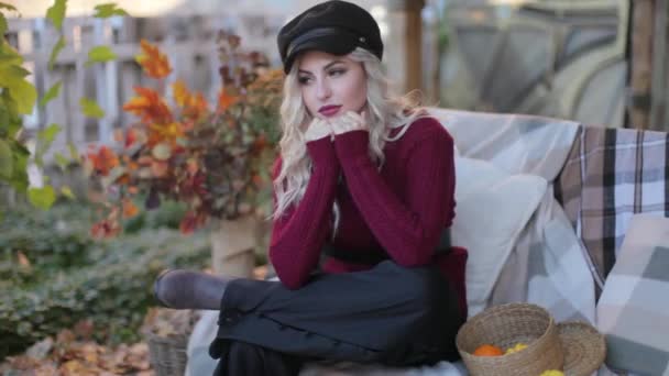 Blonde girl in a red sweater at a photo shoot — Stock Video