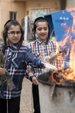 Believers Israelis Burn all flour products before a religious holiday of Passover clipart