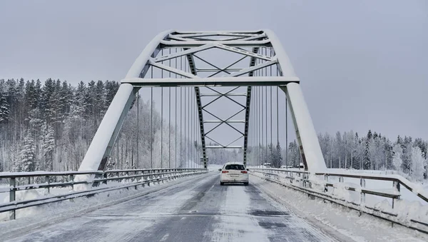 We drive in a magnificent winter landscape with icy roads and beautiful views. The road goes from Lule on the coast of Norrbotten to Jokkmokk in Swedish Lapland and on to a small lake far out in the wilderness — Stock Image Drive Magnificent Winter Landscape Icy Roads Beautiful Views Road Goes Stock Photo