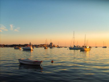 Sunset over the harbor with plenty of sailboats